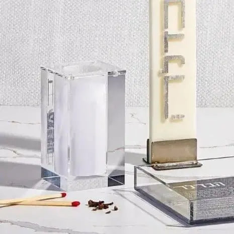 Clear acrylic Block Match Jar by Waterdale Collection with brass-colored metal base, displayed on white surface near notebooks and decorative items.