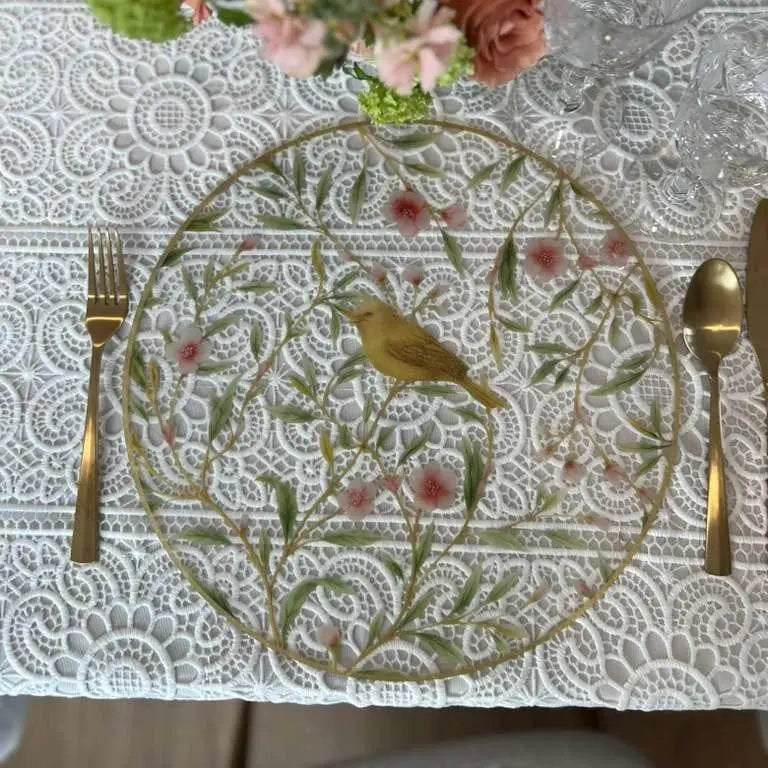 Floral Bird Charger plate with ornate gold botanical design and bird motifs, set with formal dining place setting and fresh flowers.