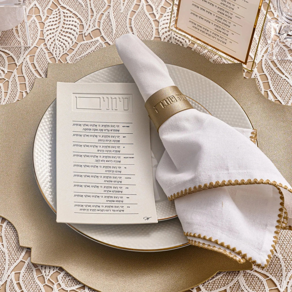 Gold leather napkin wraps on white plates with menu card, Rosh Hashana table setting by Waterdale Collection
