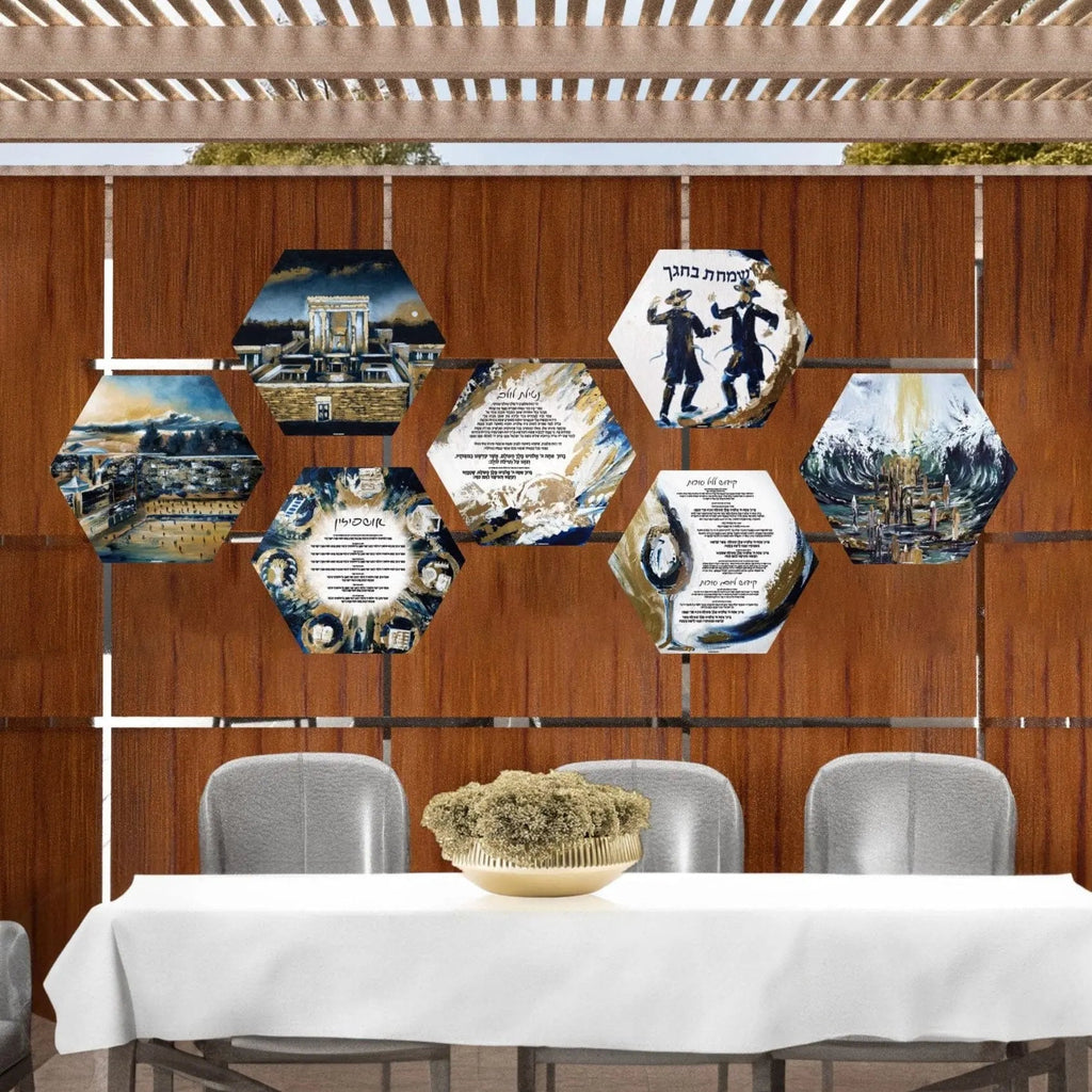 Seven hand-painted hexagon sukkah decorations hanging from strings against a wooden wall, featuring blue and white Judaica designs displayed above a table.
