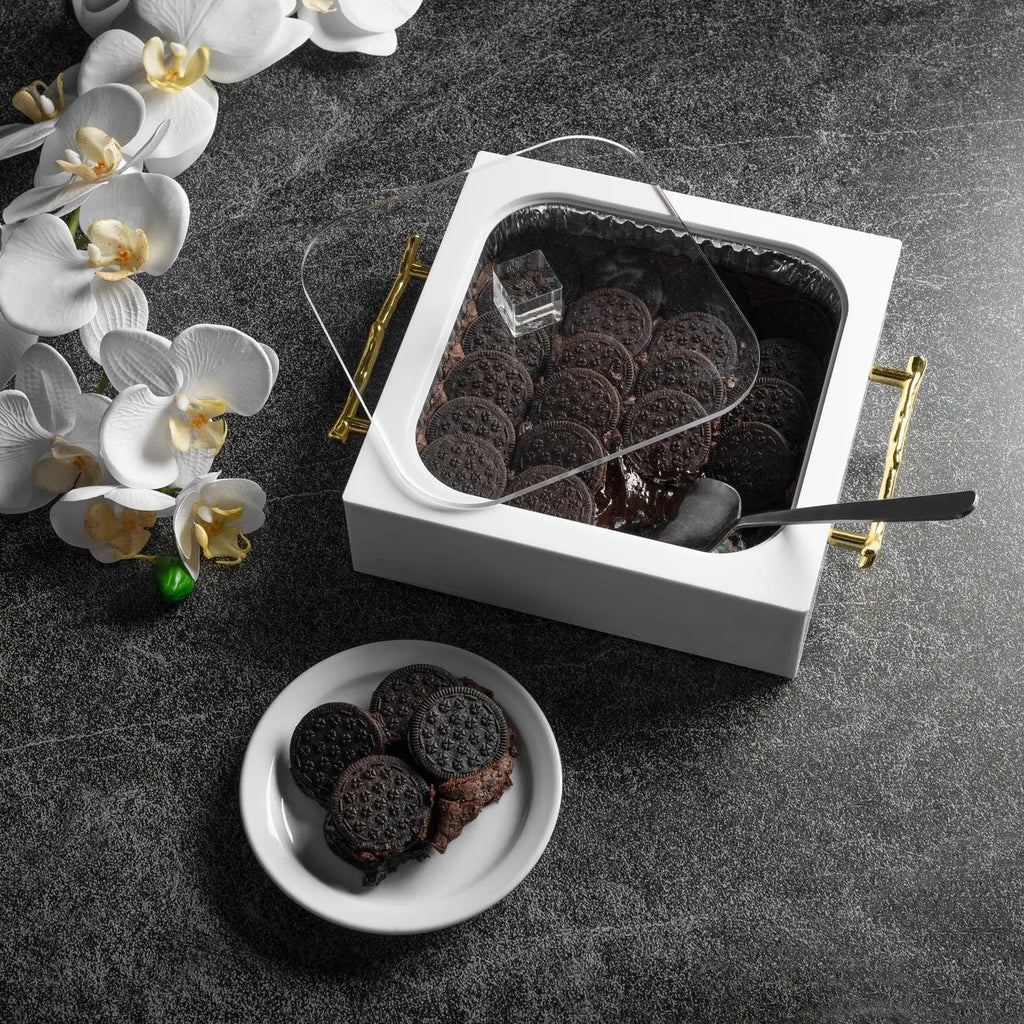 White ceramic 8x8 pan holder by Waterdale Collection with dark serving dish, styled with white orchids and gray surface
