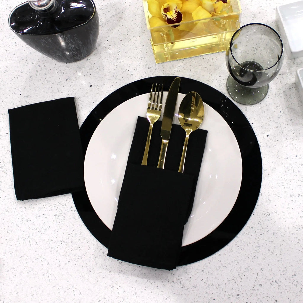 Black round table charger with gold cutlery holder and place setting, elegant tabletop dinnerware by Waterdale Collection.