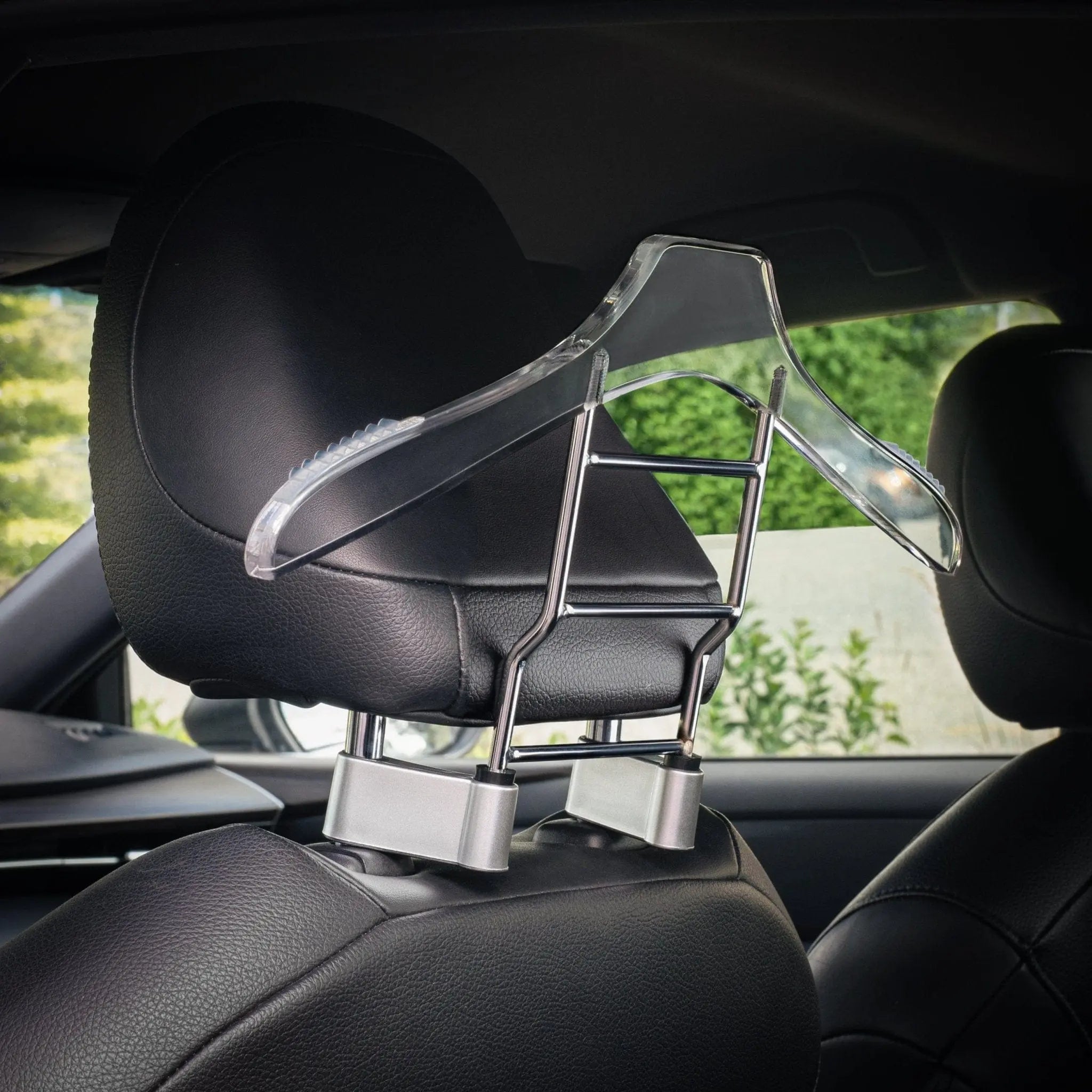 Black car hanger mounted on vehicle headrest, displaying organizational functionality with storage compartments for essentials.
