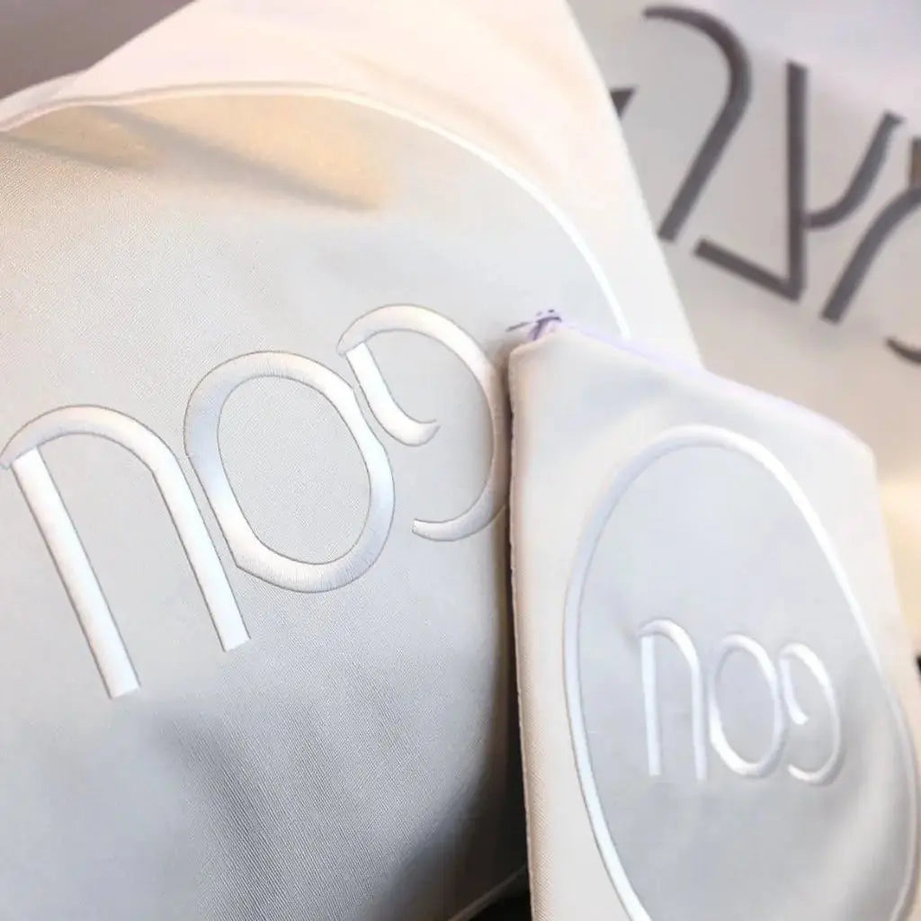 White leather Circle Pesach Set with modern minimalist design, featuring elegant curved text detailing on the plates