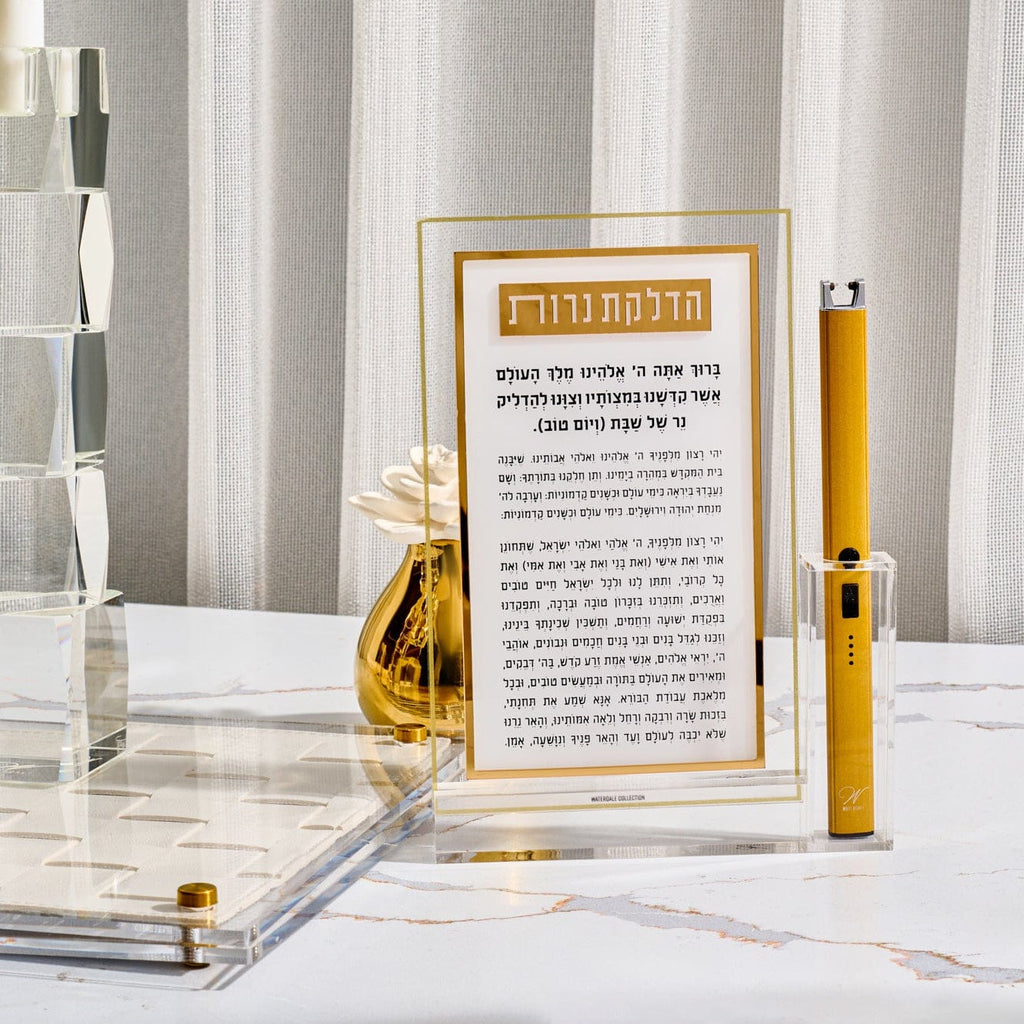 Classic 2.0 Hadlokas Neiros Card with Lighter featuring gold-accented Hebrew Shabbat candle lighting prayer in clear acrylic frame, paired with sleek gold rechargeable lighter, modern elegant Judaica tabletop display.