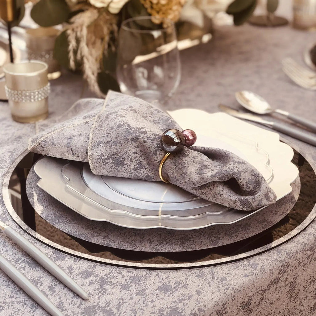 Classic Chargers with silver border and grey linen texture, layered place setting with napkin and cutlery detail