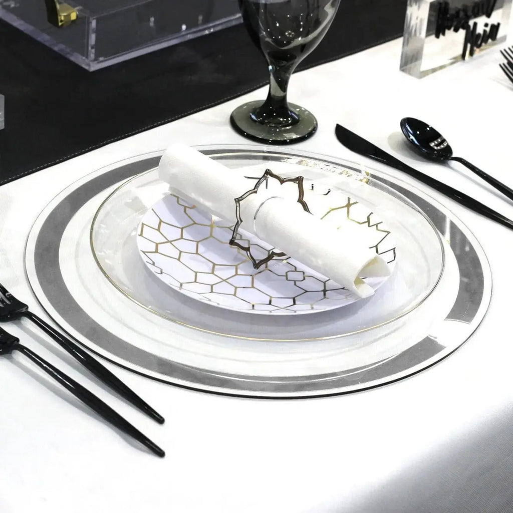 Classic Charger with silver border and intricate blue pattern detail, set at an elegant place setting with white plate and black utensils.