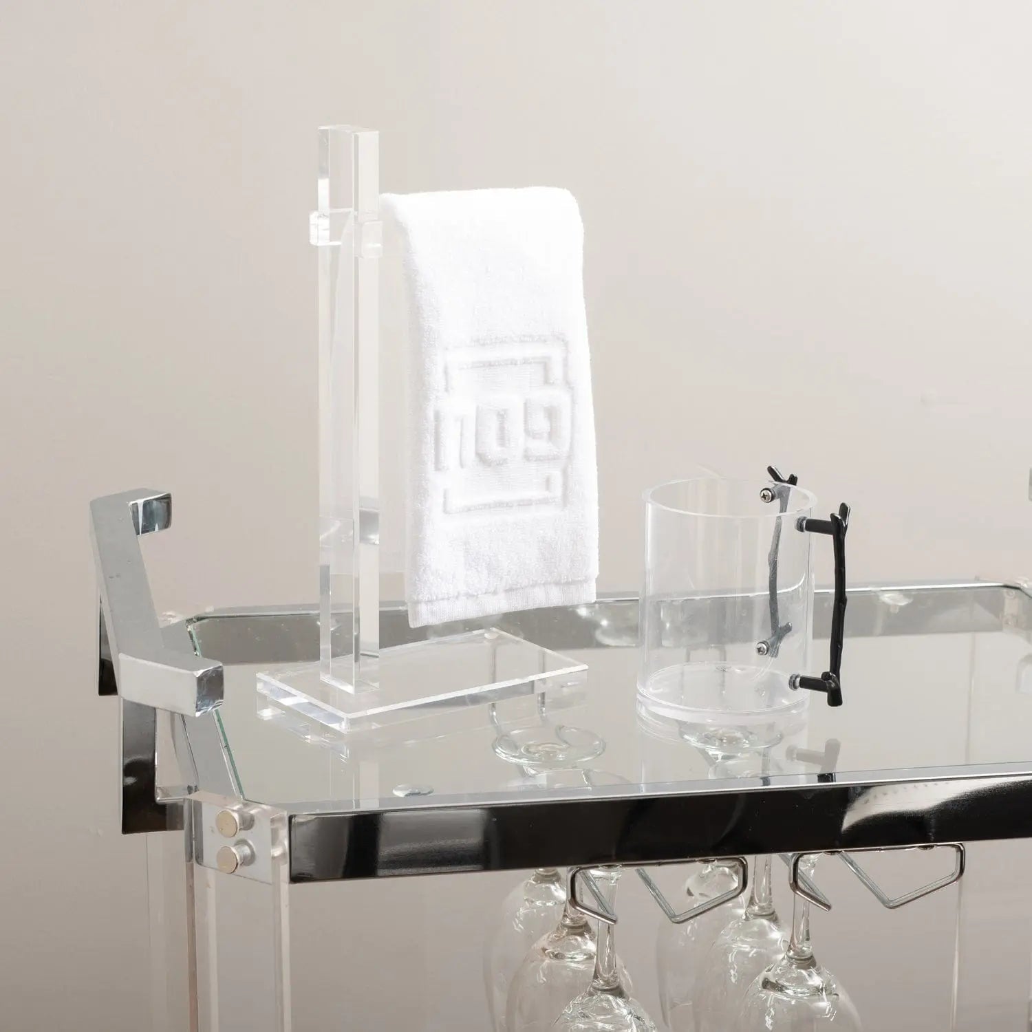 Clear acrylic finger towel stand by Waterdale Collection displaying white towels, featuring a modern minimalist design perfect for bathroom vanities and countertops.