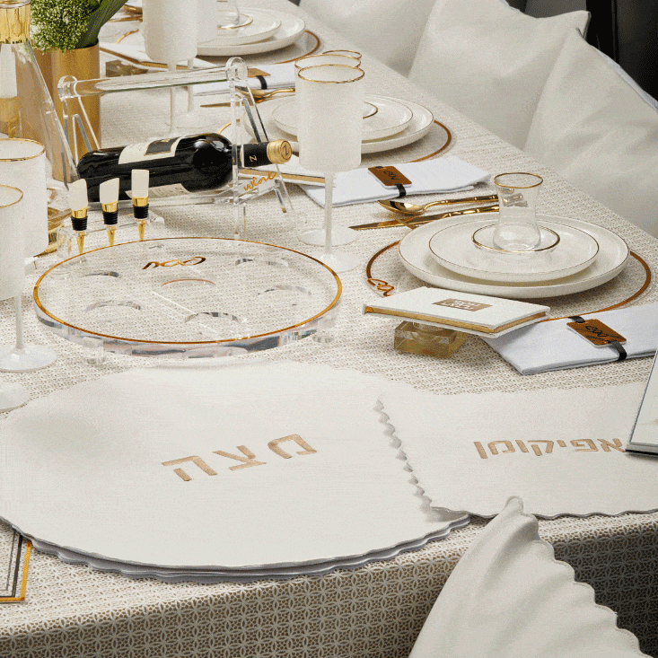 Classic Pesach chargers by Waterdale Collection in elegant silver and black borders, displayed on a festive holiday table setting.