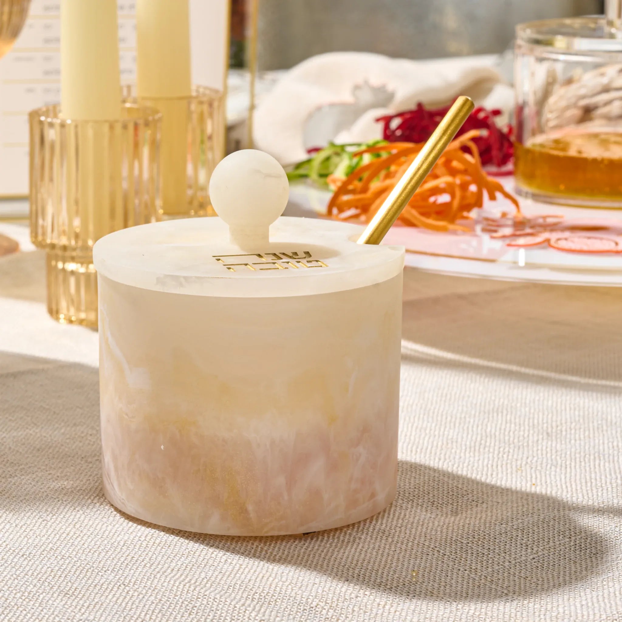 Gold round resin honey dish in a marbleized finish for Rosh Hashanah