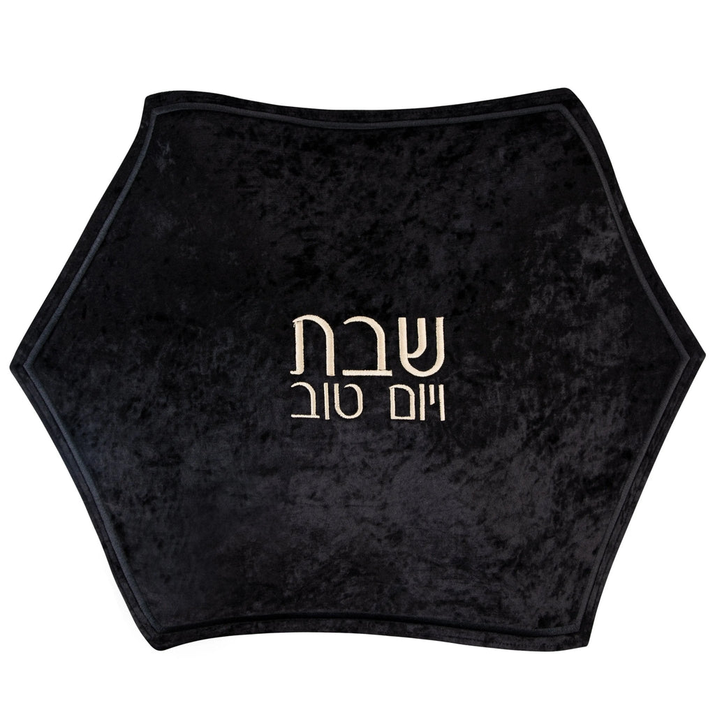 Black crushed velvet hexagon challah cover with silver Hebrew text, ideal for Shabbat table settings.