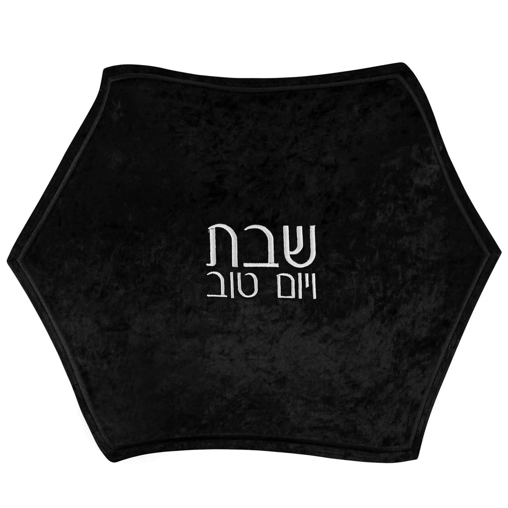 Crushed black velvet hexagon challah cover with silver Hebrew text, perfect for Shabbat table settings.