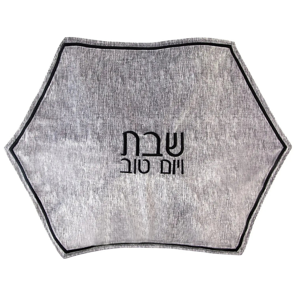 Gray crushed velvet hexagon challah cover with Hebrew text, featuring a soft texture and navy trim for Shabbat table.