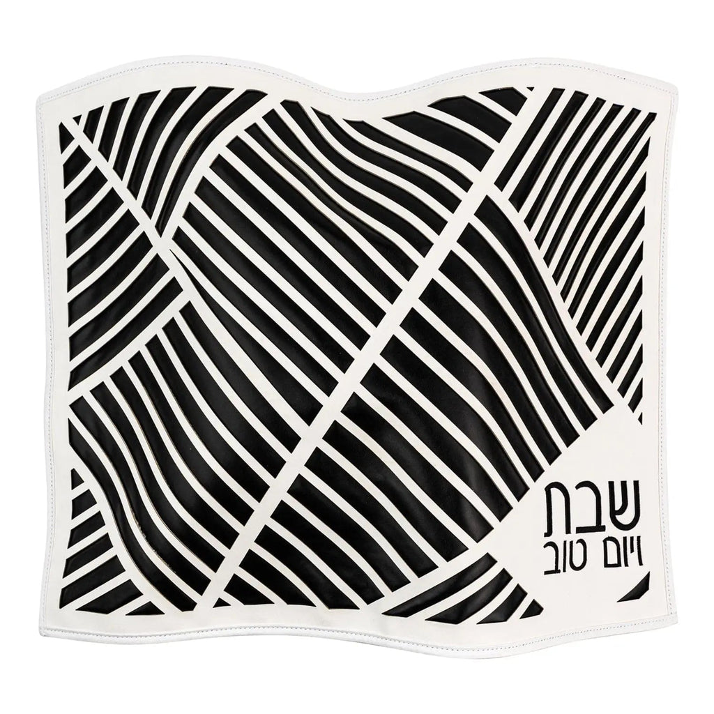 Black leather challah cover with diagonal laser-cut geometric pattern and metallic accents, Shabbat table décor by Waterdale Collection.