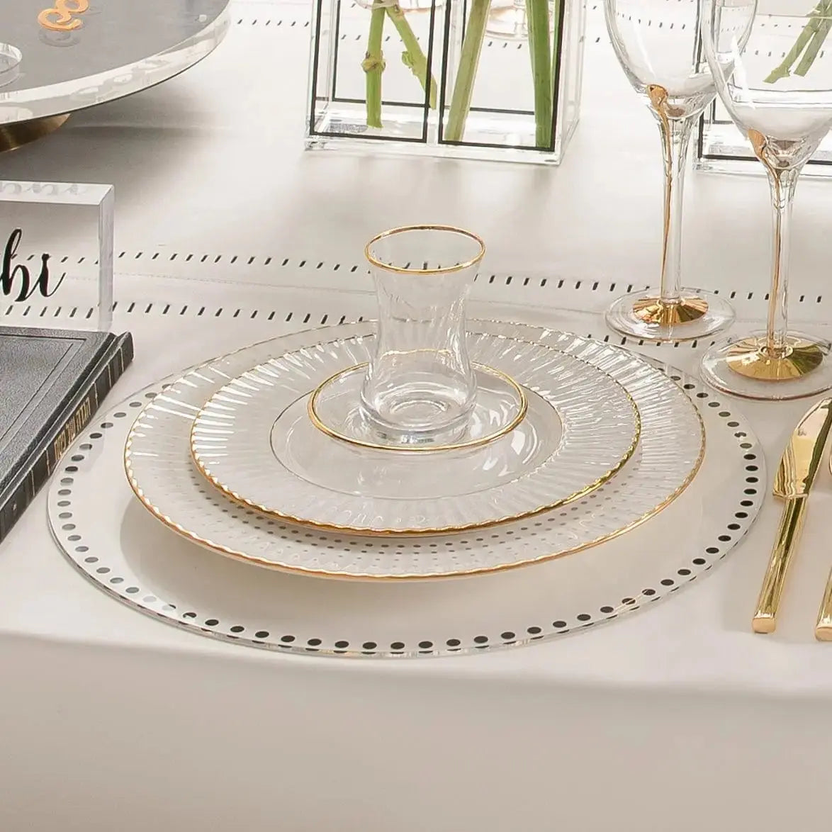 Waterdale Collection Dot Border Chargers with silver beaded edges displayed on a formal place setting with white plates and gold cutlery.