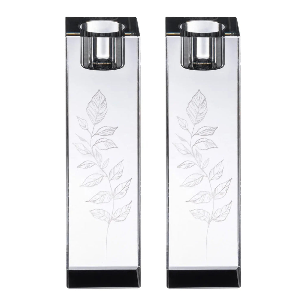 Pair of tall crystal candlesticks with delicate leaf engravings and black bases for Shabbat candle lighting.