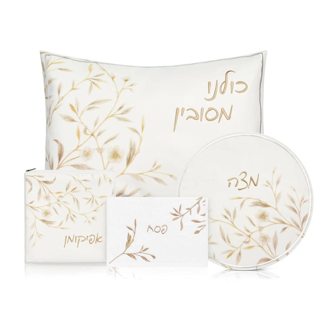 Floral Bird Pesach Set in gold and white featuring matching placemats, napkins, and decorative plates with leaf design
