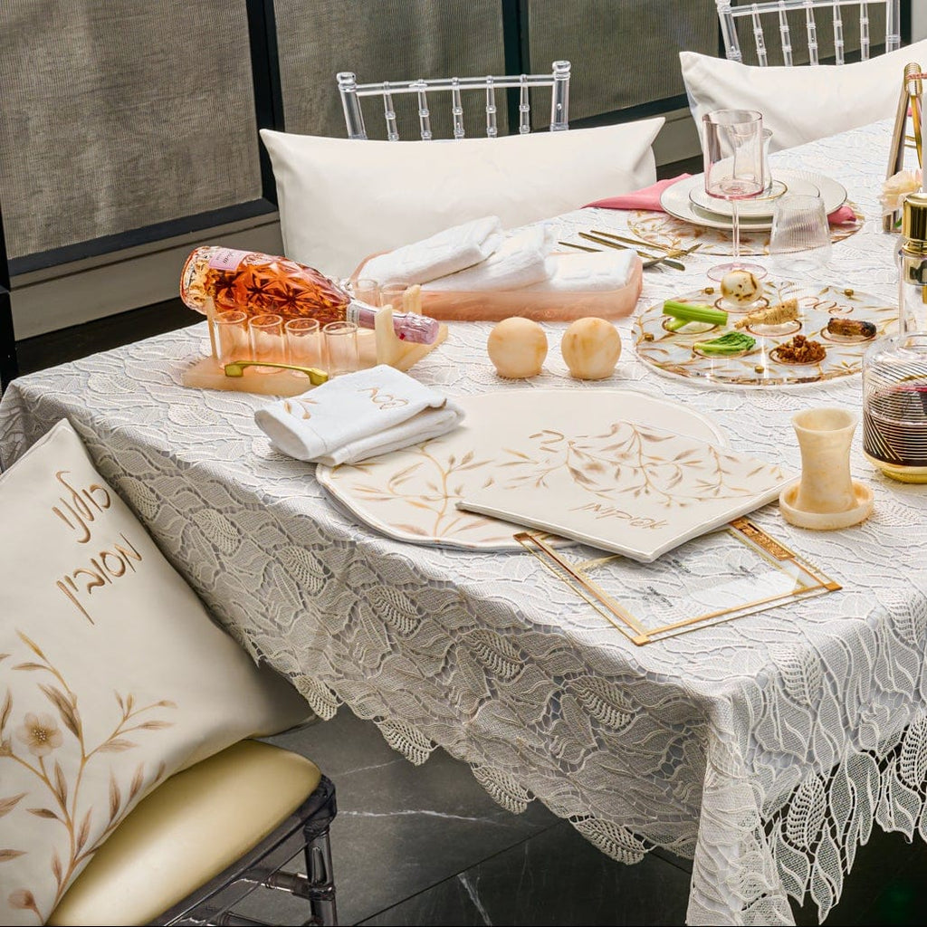 Waterdale Collection Gold Floral Bird Pesach Set styled on an elegant Seder table, featuring cream matzah cover, matching afikoman bag and coordinating pillow with soft gold botanical design, luxury Passover table décor and modern Judaica holiday gift set