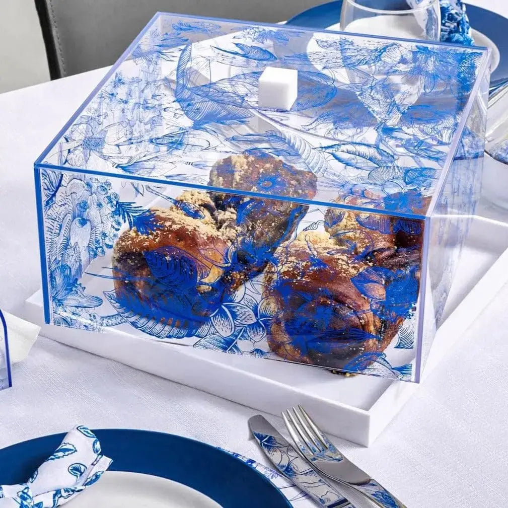 Decorative cake dome with Frech toile blue and white design on a table setting with plates and cutlery