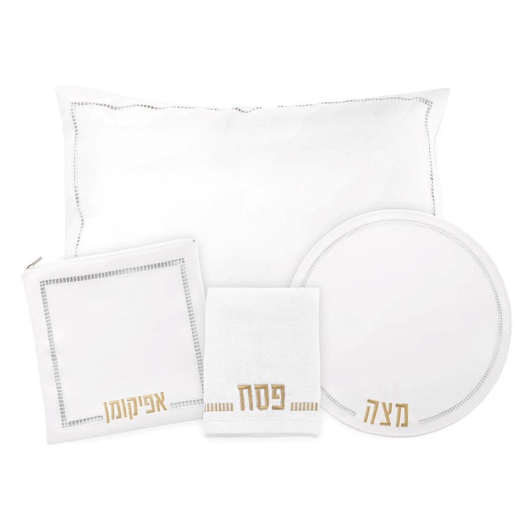 Hemstitched Pesach set with white linens including tablecloth, napkins, plate charger, and matching dinnerware in elegant leather trim design.