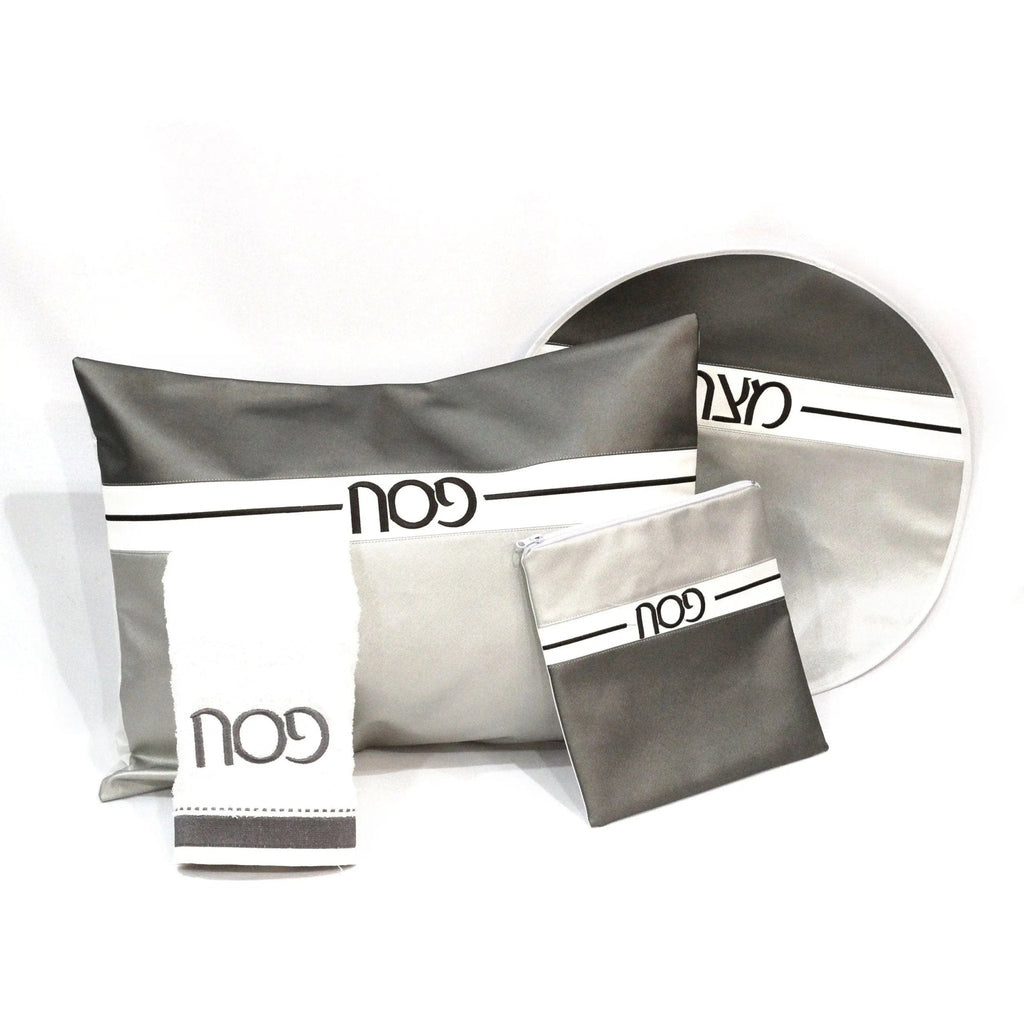 Horizontal Pesach Set in gray and white featuring leather components, displayed with organized tabletop elements for Passover.