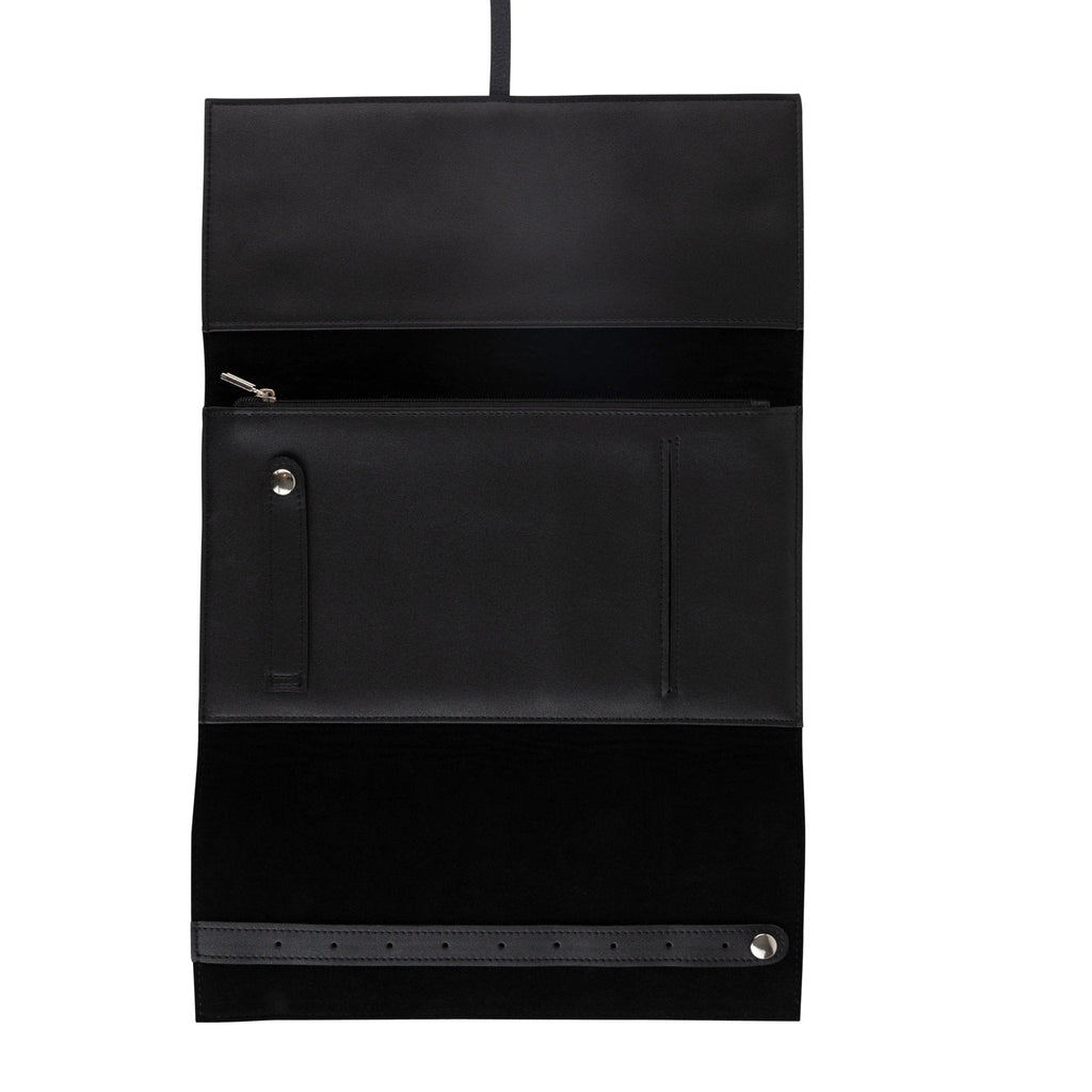 Black leather jewelry roll with compartments and snap closure, displayed flat against white background