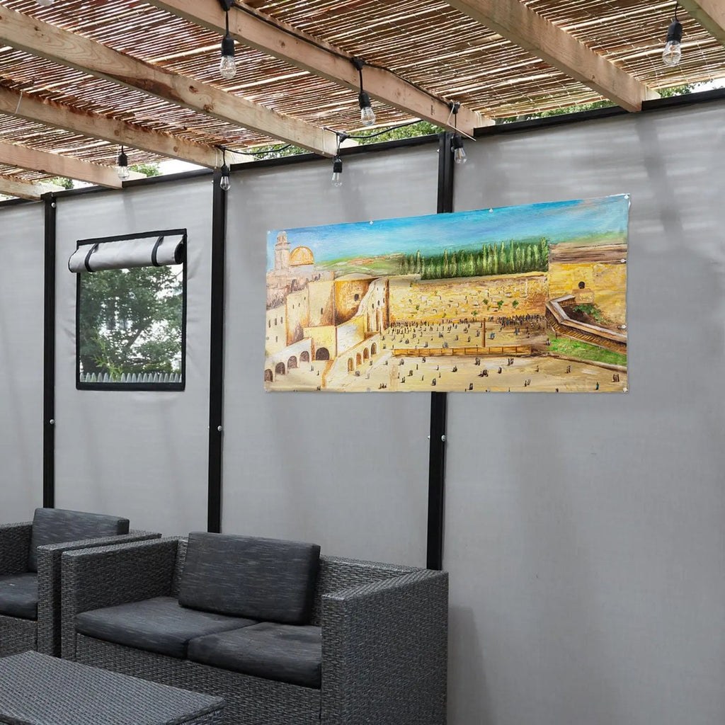 Kosel in Color vinyl Sukkah decoration mounted on gallery wall, featuring golden landscape painting in warm earth tones, displayed above black seating.