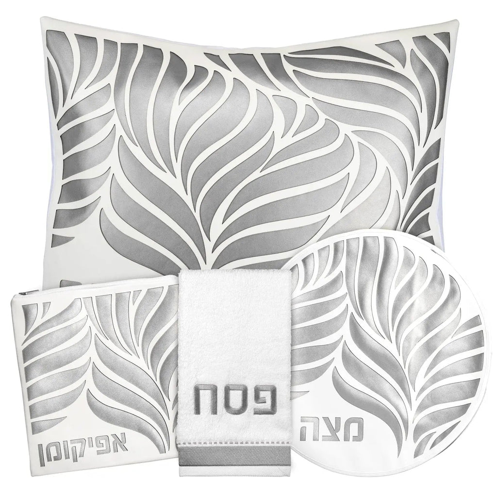 Leaf Laser Cut Pesach Set by Waterdale Collection featuring gray and white leaf-patterned leather placemats and matching napkin rings for holiday table settings.