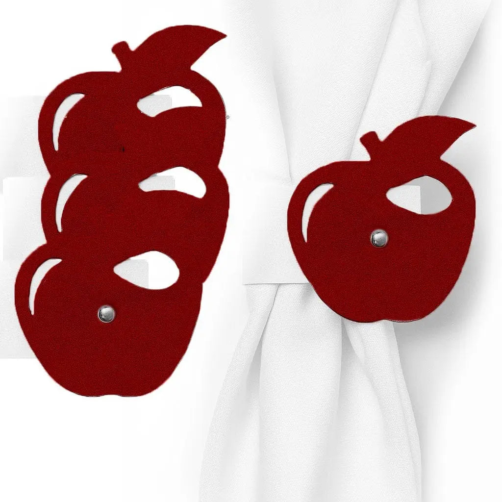 Three burgundy leather apple-shaped napkin rings stacked together with white napkins draped through them.