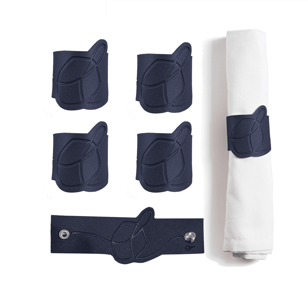 Five navy leather dreidel napkin rings displayed with a rolled white napkin, showing the Chanukah holiday tabletop décor set by Waterdale Collection.