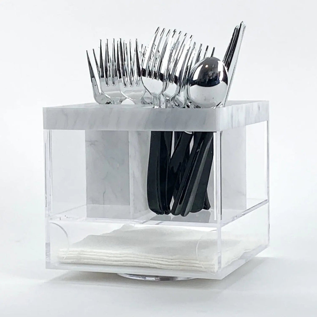 Marble swivel silverware caddy with clear compartments holding forks, knives, and spoons, rotating base design for easy access.