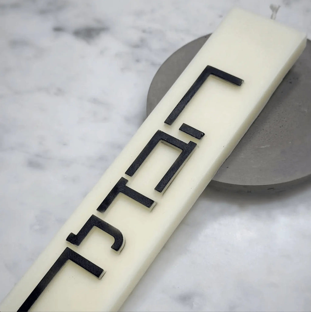 Minimalist Havdalah candle holder in cream with geometric black line design on marble surface