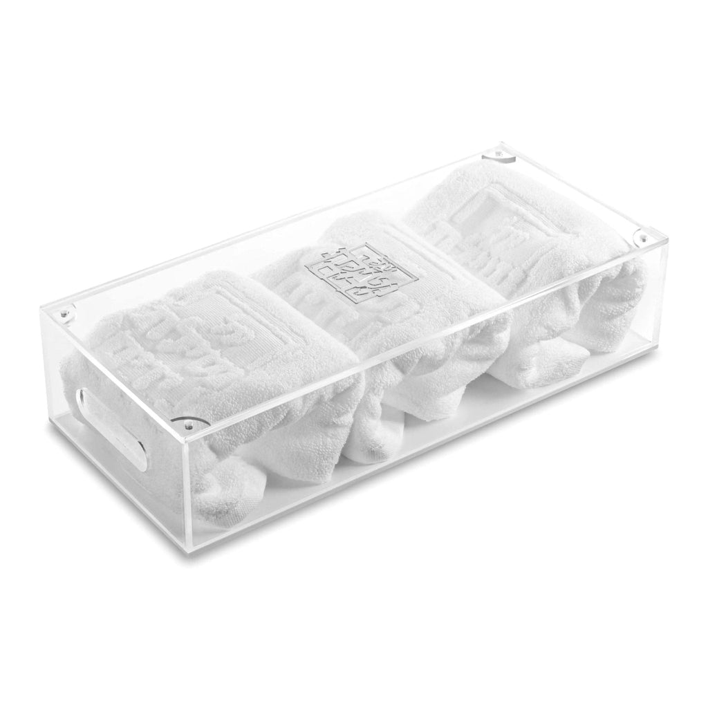 Clear acrylic Netilas Yadayim towel box by Waterdale Collection holding rolled white towels, designed for handwashing rituals.