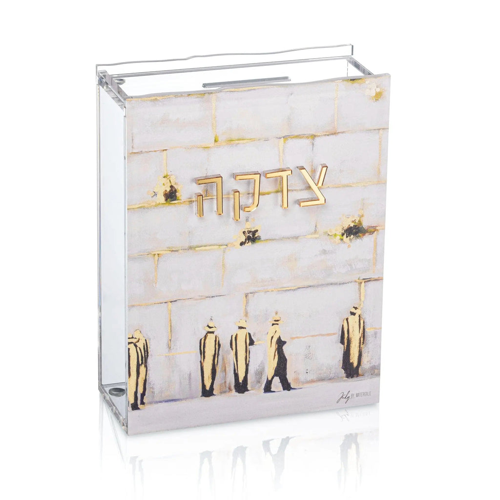 Clear acrylic Tzedakah box by Painted by Judy featuring gold Jerusalem Kosel design with compartments and metal hardware for charitable giving.