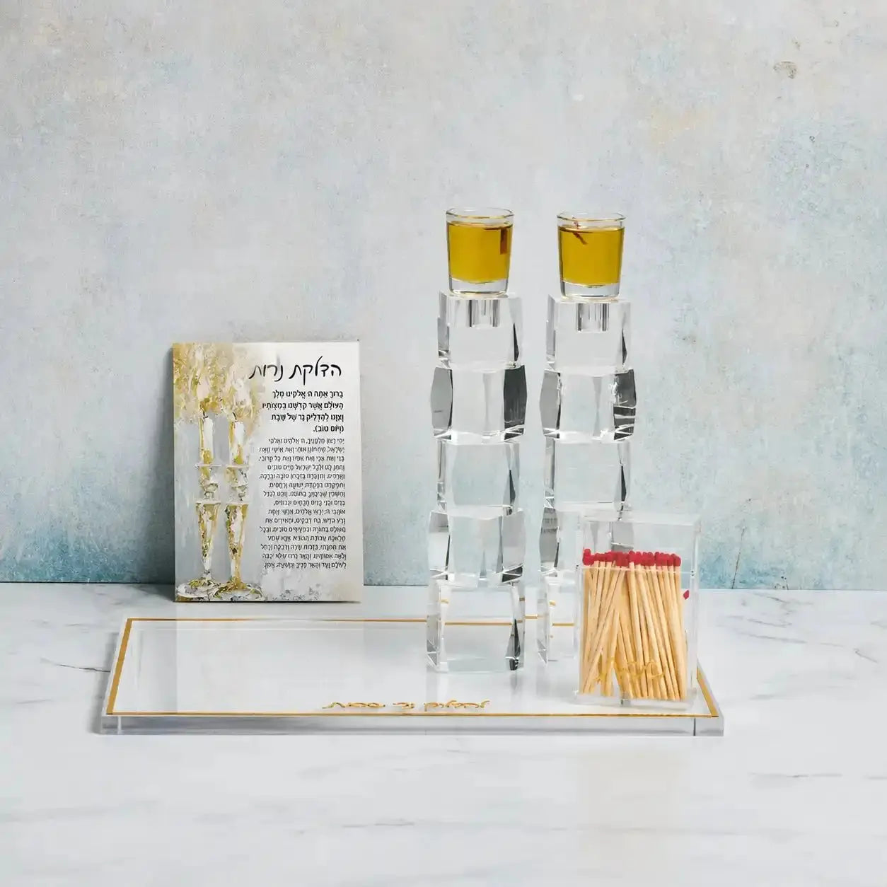 Painted Gold Candles Tabletop Hadlokas Neiros plaque with two white candle holders featuring gold-painted tops, displayed on white wooden base with prayer card.