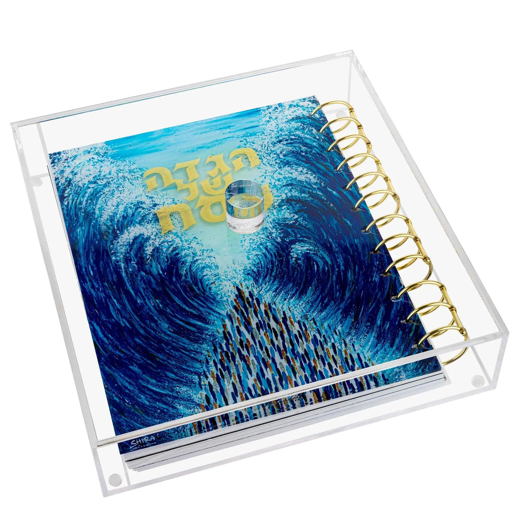 Painted Krias Yam Suf Haggadah in clear lucite case with blue ocean wave artwork and gold accents, Passover Pesach holiday book.