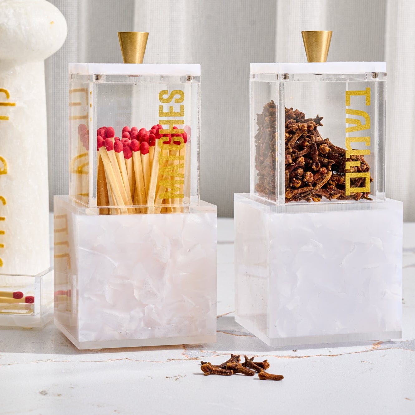 Pearlstone Block Besamim Jar featuring a clear lucite spice container with gold Hebrew “Besamim” lettering and a sleek gold-tone knob, set atop a solid pearlstone-style resin block base.