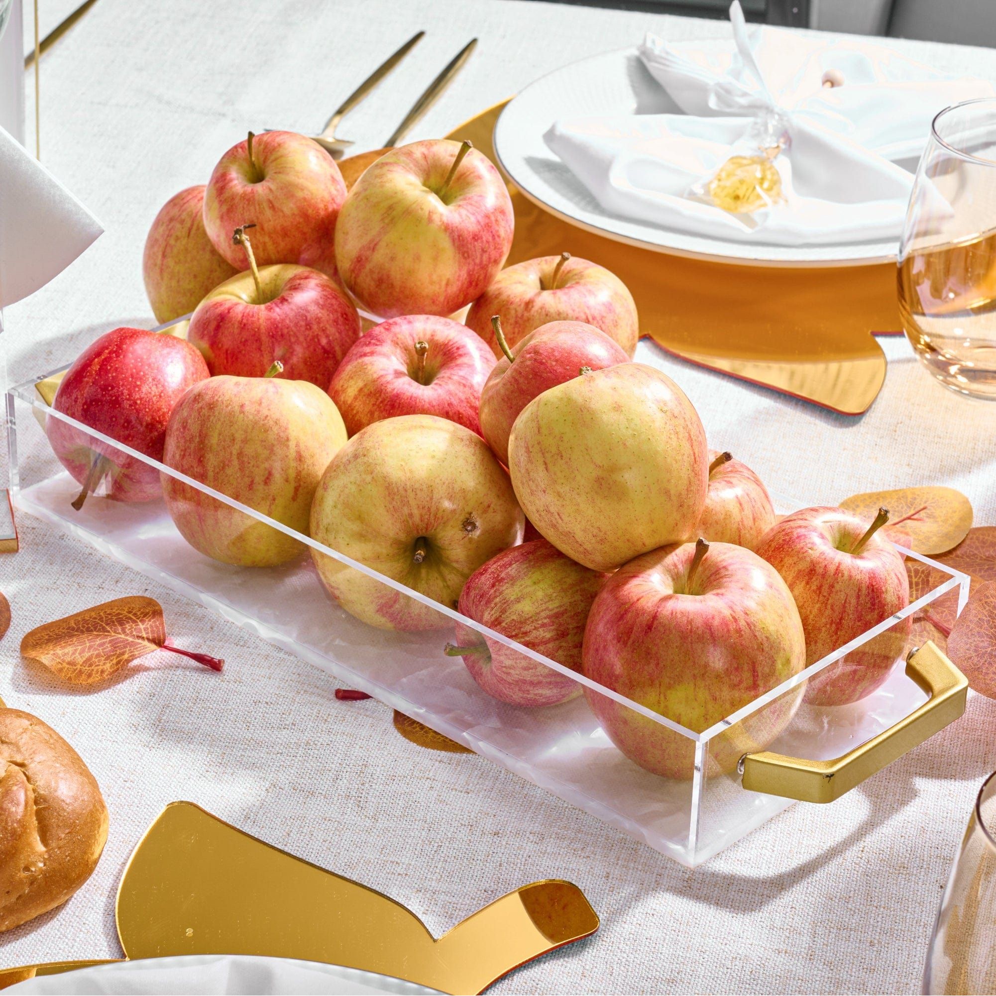 Fresh apples are displayed in a Pearlstone Bread / Towel Tray on an elegant holiday table setting.