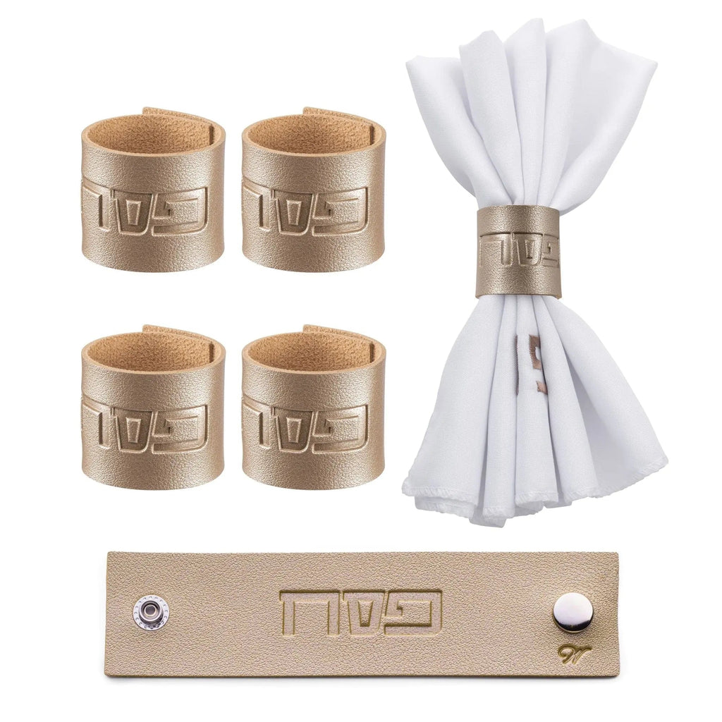 Four gold leather Pesach napkin rings displayed with a white fanned napkin and gold bar, perfect for holiday table settings.