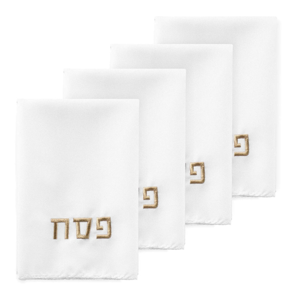 White Pesach napkins from Waterdale Collection featuring embroidered Hebrew text, displayed in a set of four folded napkins for holiday table settings.
