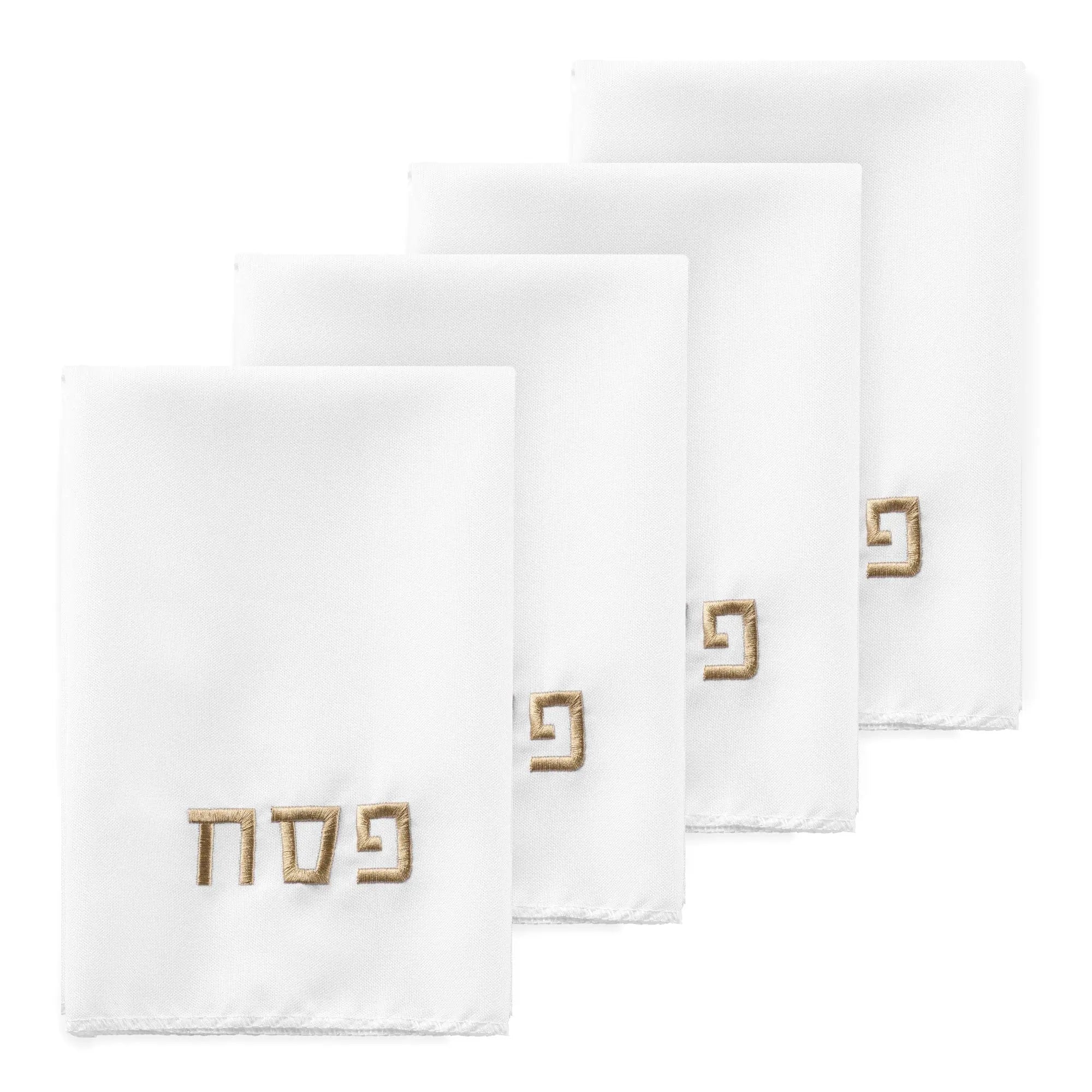 White Pesach napkins from Waterdale Collection featuring embroidered Hebrew text, displayed in a set of four folded napkins for holiday table settings.