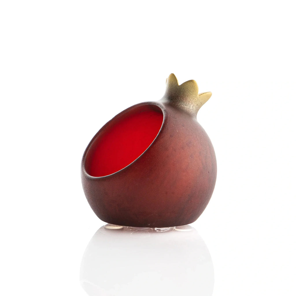Deep red resin pomegranate honey dishes set at each place for Rosh Hashonah