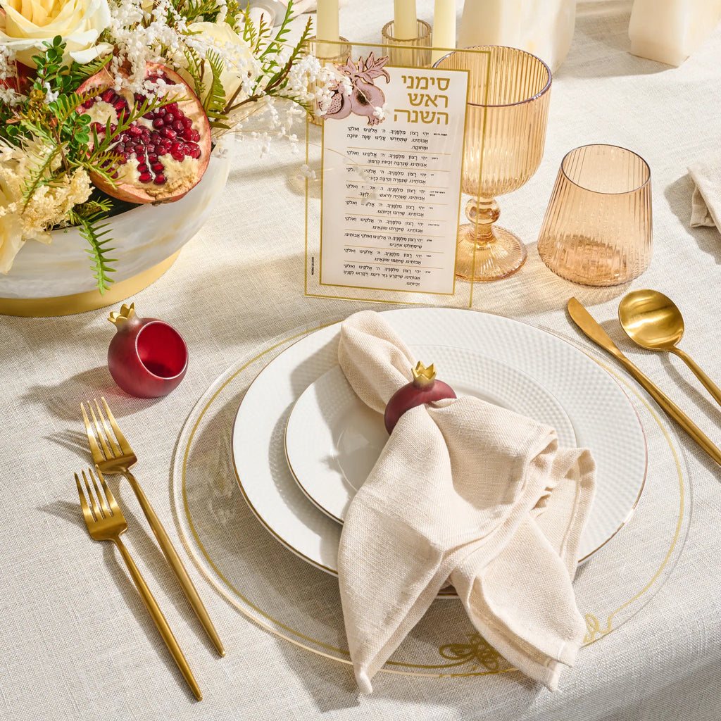 Deep red resin pomegranate napkin rings for a Rosh Hashonah table