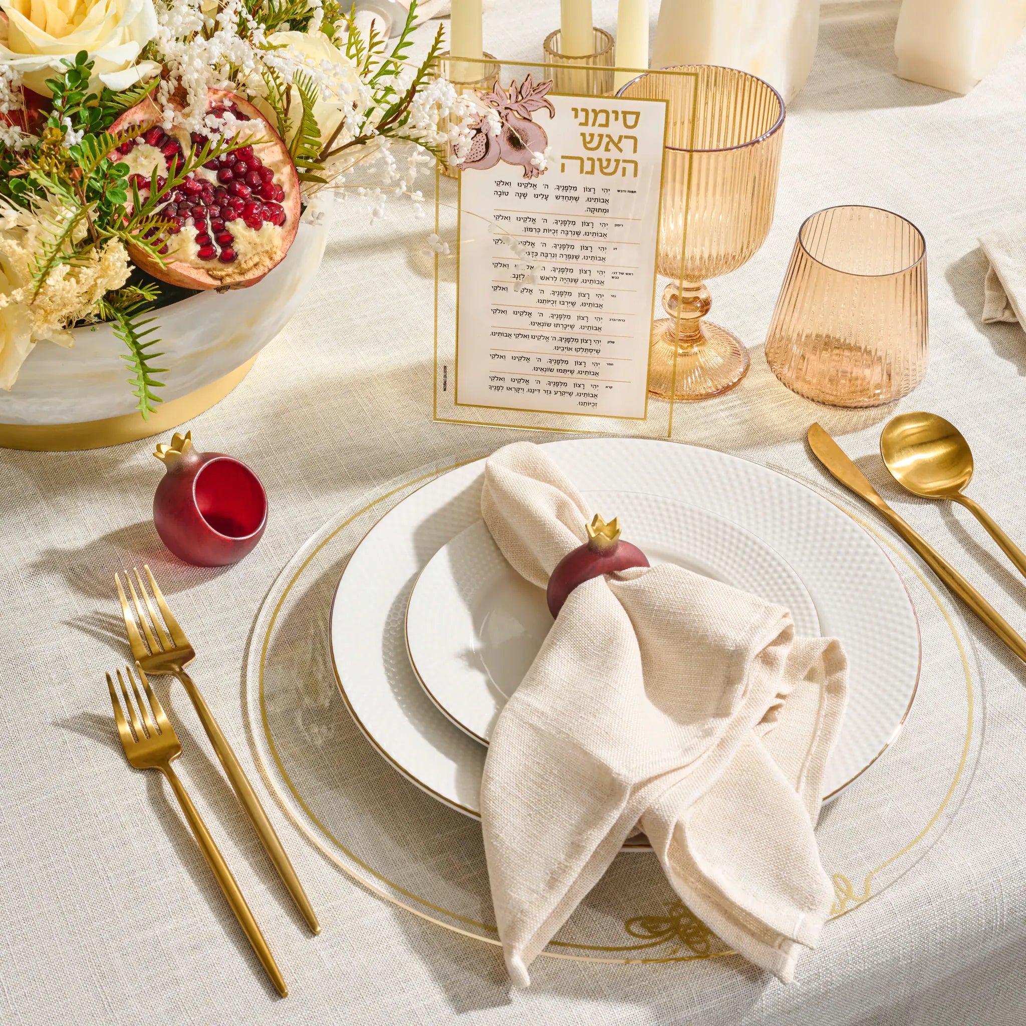 Deep red resin pomegranate napkin rings for a Rosh Hashonah table