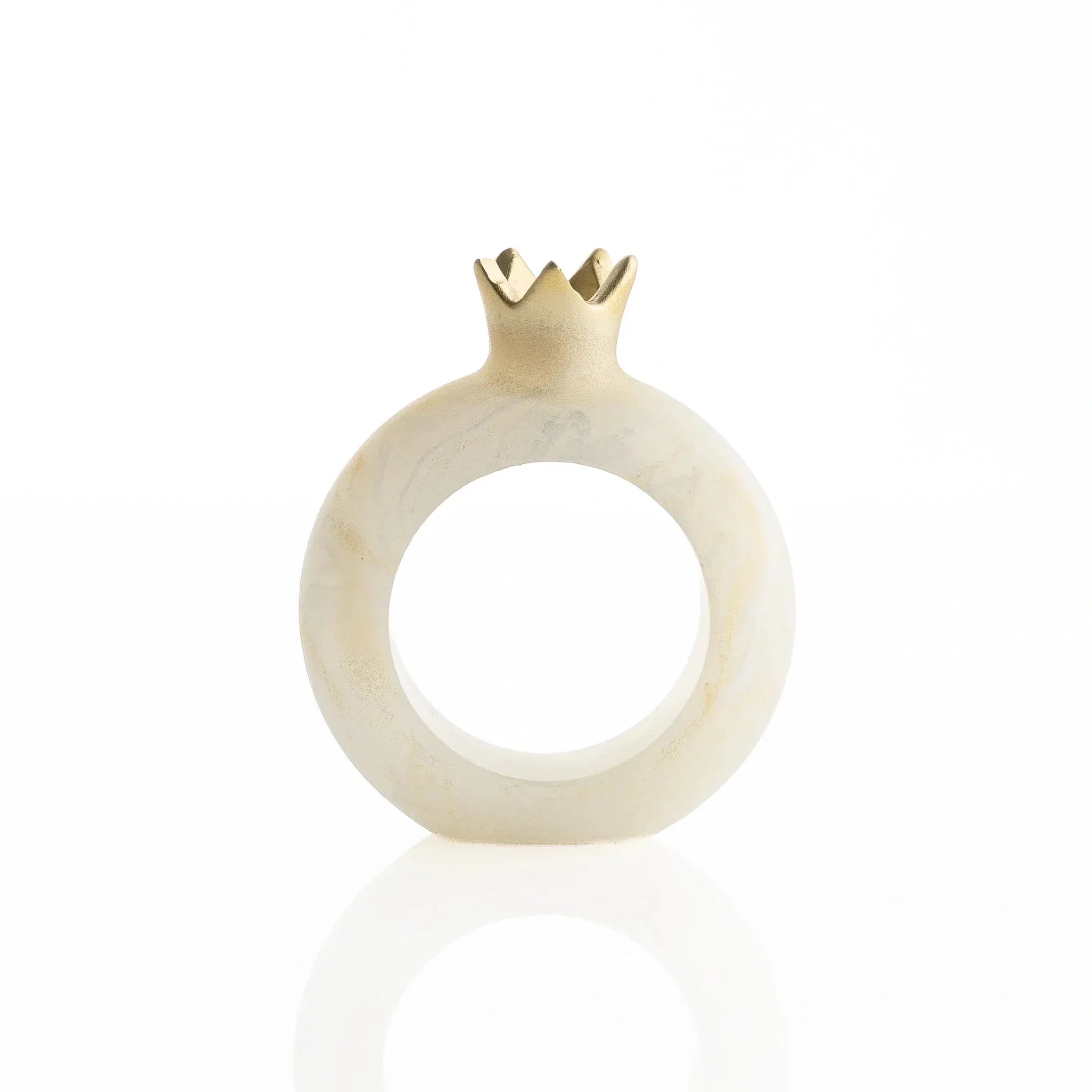 Gold resin pomegranate napkin rings styled on a holiday table setting