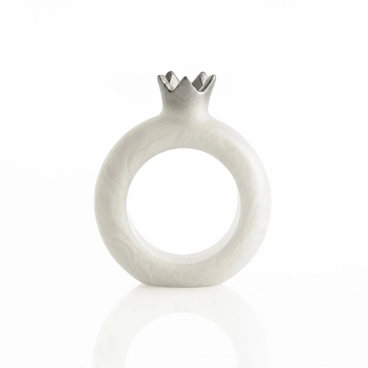 Silver resin pomegranate napkin rings framing napkins at each seat