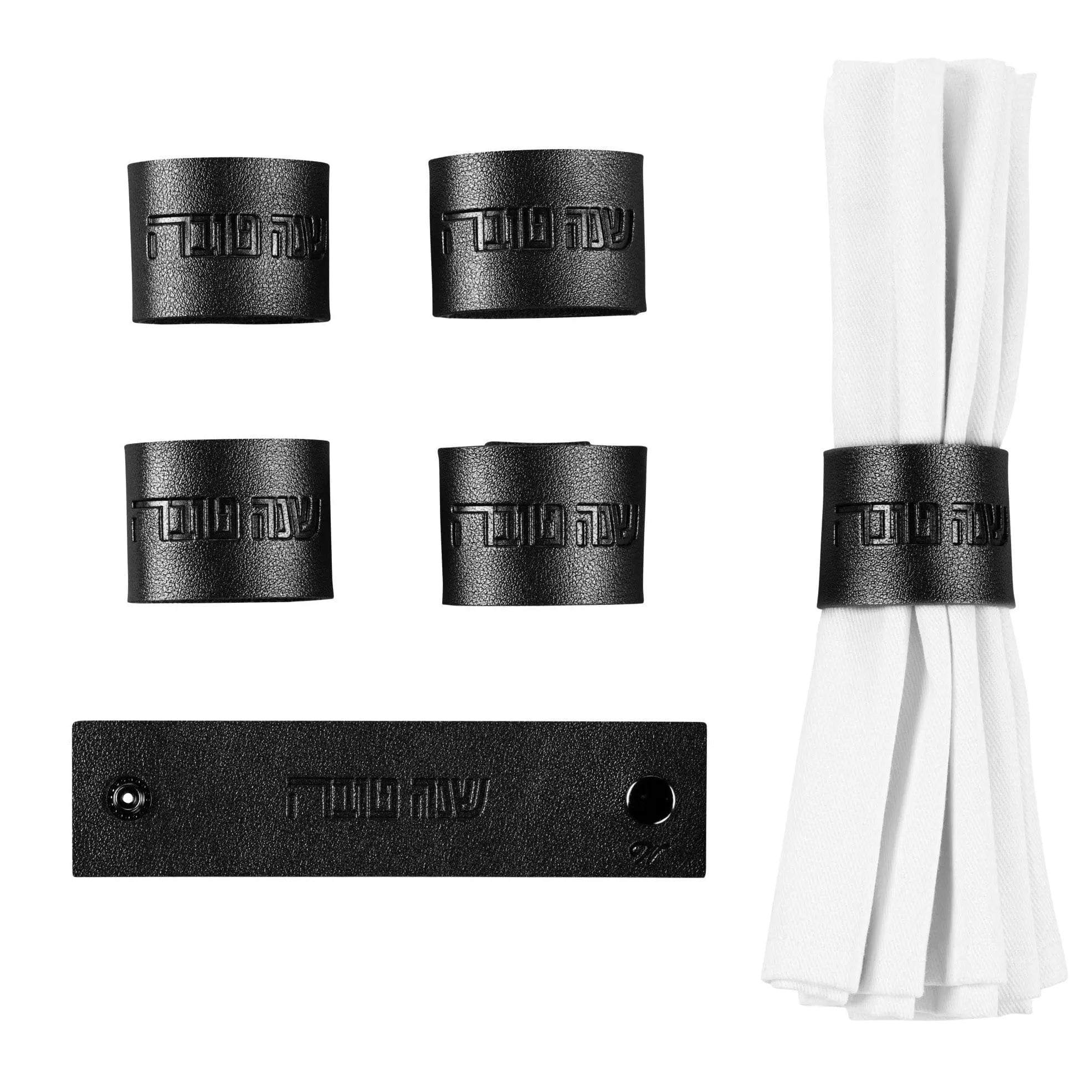 Set of six black leather Rosh Hashana napkin wraps with coordinating white napkins and black storage band included.