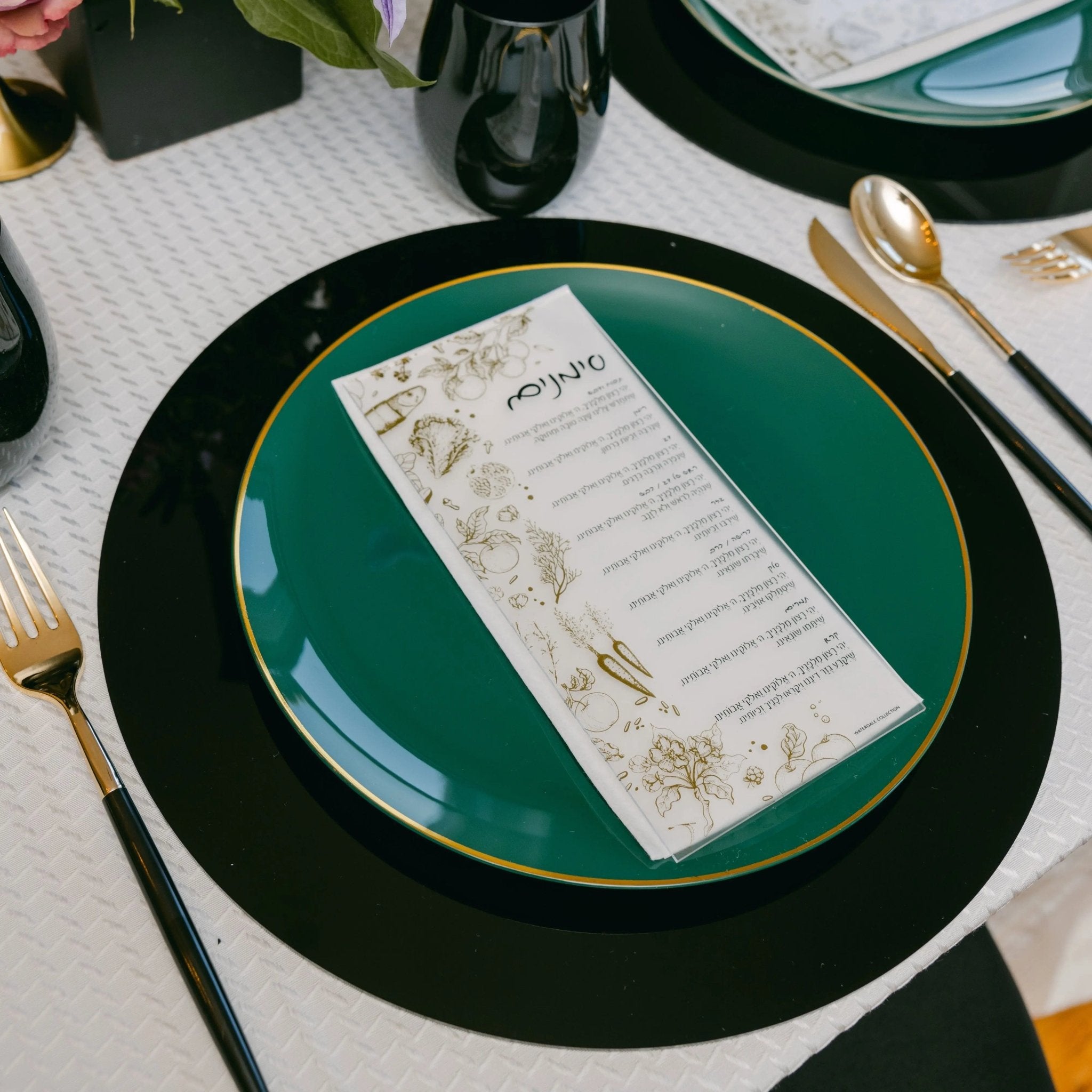 Toile Simanim Card in cream lucite displayed on green plate at formal table setting with place card holder