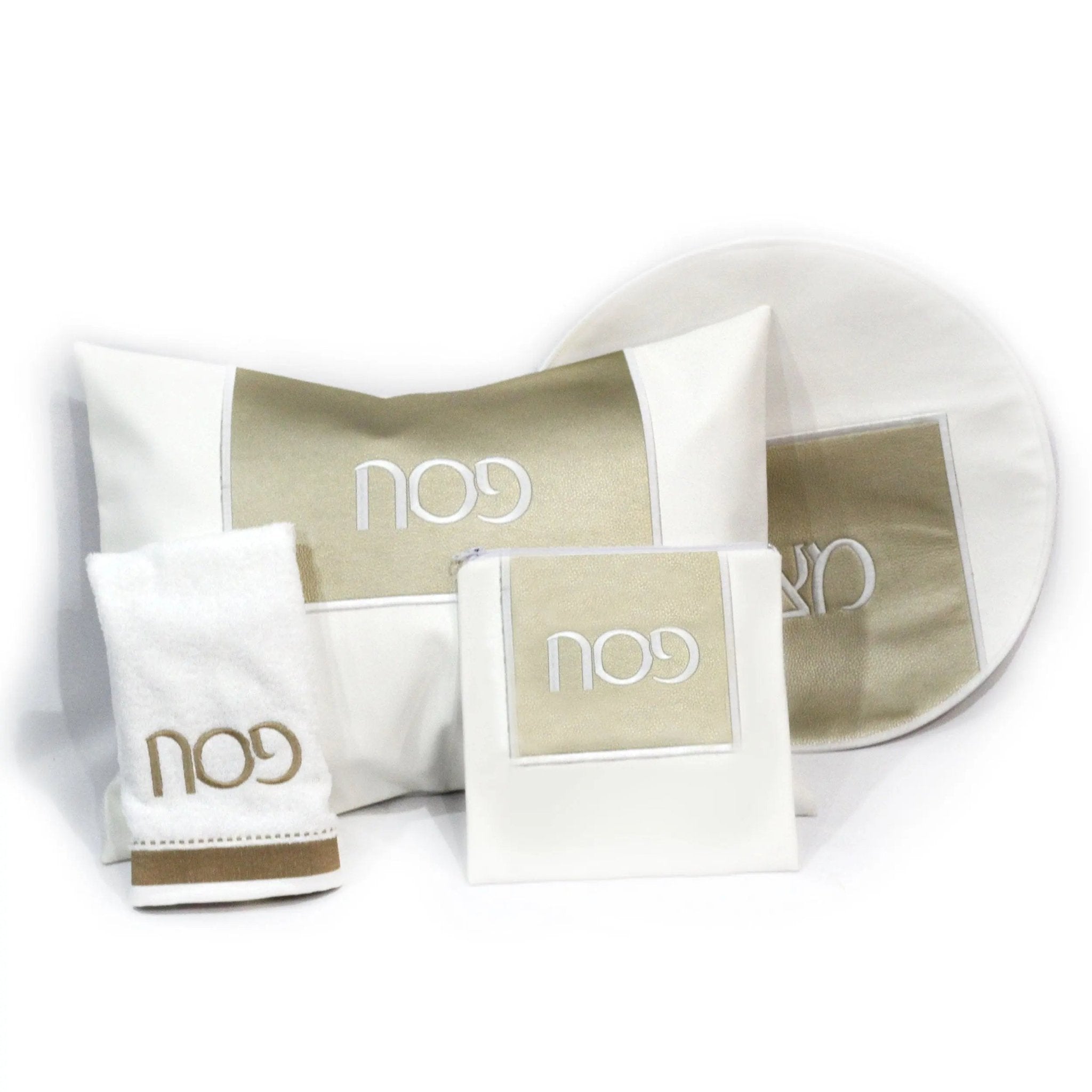Square Pesach Set by Waterdale Collection featuring white leather dishes with gold accents, displayed with matching tableware accessories for holiday dining.