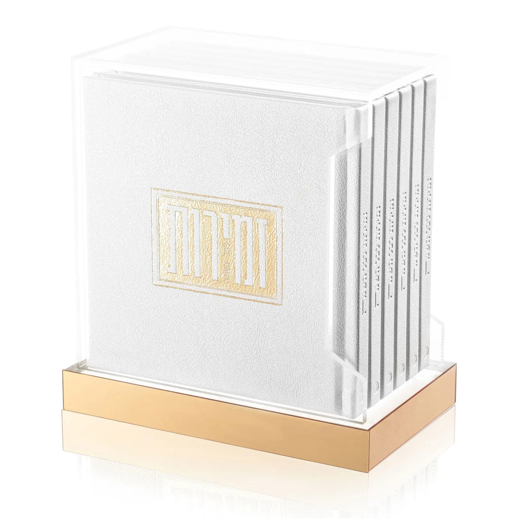 White and gold Shabbos Zemiros Bencher Set with wooden base, featuring multiple cream prayer books with gold lettering displayed on stand.